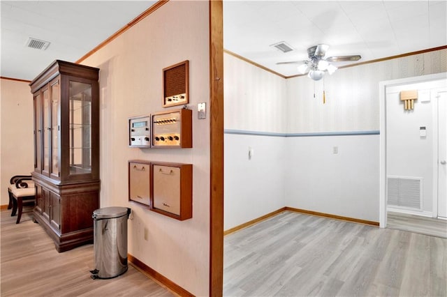 interior space featuring ornamental molding and light hardwood / wood-style floors