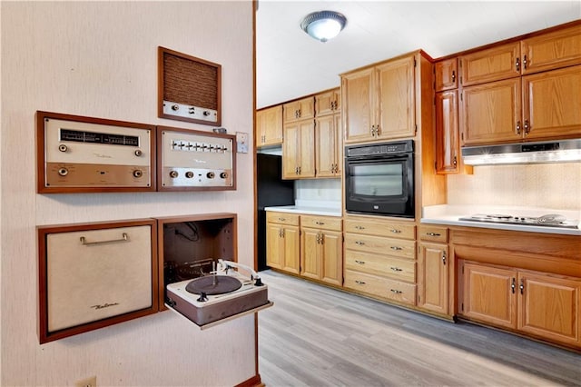 kitchen with light hardwood / wood-style floors, gas stovetop, and oven