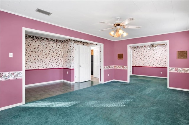 spare room with ceiling fan, crown molding, and dark carpet