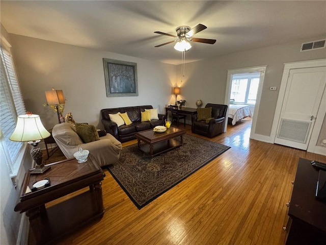 living room featuring hardwood / wood-style flooring and ceiling fan