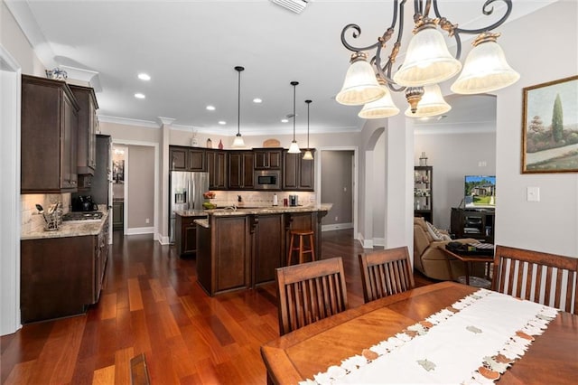 dining space featuring dark hardwood / wood-style flooring and crown molding