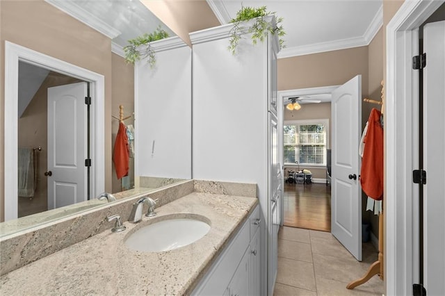 bathroom featuring tile patterned floors, ceiling fan, crown molding, and vanity