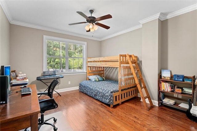 bedroom with hardwood / wood-style floors, ceiling fan, and ornamental molding