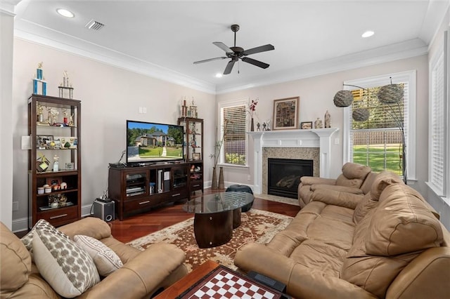 living room with a healthy amount of sunlight, crown molding, ceiling fan, and wood-type flooring