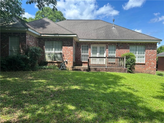 5901 Eastridge Pl, Mobile, AL 36608 - view of front of house featuring brick siding, a front lawn, french doors, and roof with shingles