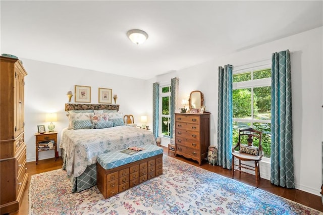 bedroom with multiple windows and hardwood / wood-style flooring