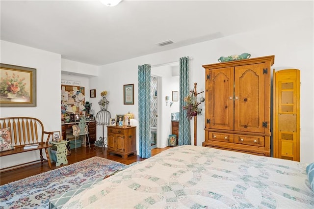 bedroom with dark hardwood / wood-style floors