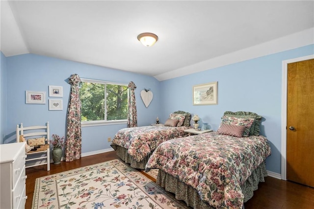 bedroom featuring hardwood / wood-style flooring and vaulted ceiling