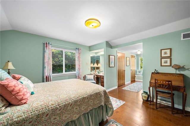 bedroom with lofted ceiling and hardwood / wood-style floors