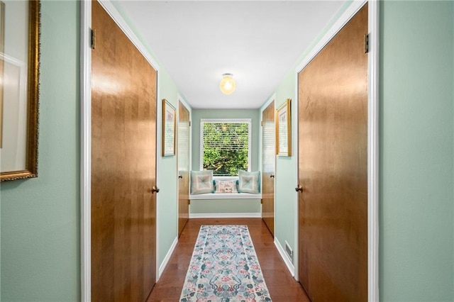 hallway with hardwood / wood-style floors