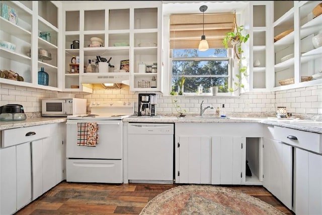 kitchen with pendant lighting, tasteful backsplash, white appliances, white cabinetry, and dark hardwood / wood-style floors