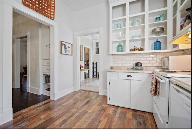 kitchen with tasteful backsplash, white range, dark hardwood / wood-style flooring, light stone countertops, and white cabinetry