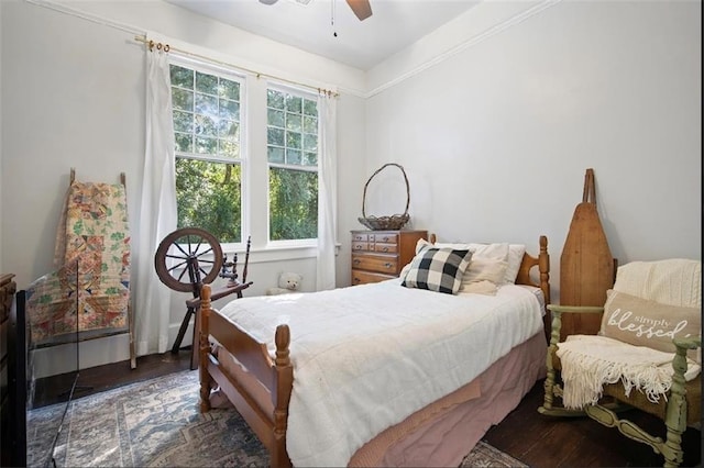 bedroom with ornamental molding, ceiling fan, and dark hardwood / wood-style floors