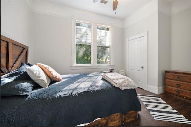 bedroom with dark hardwood / wood-style floors and ceiling fan