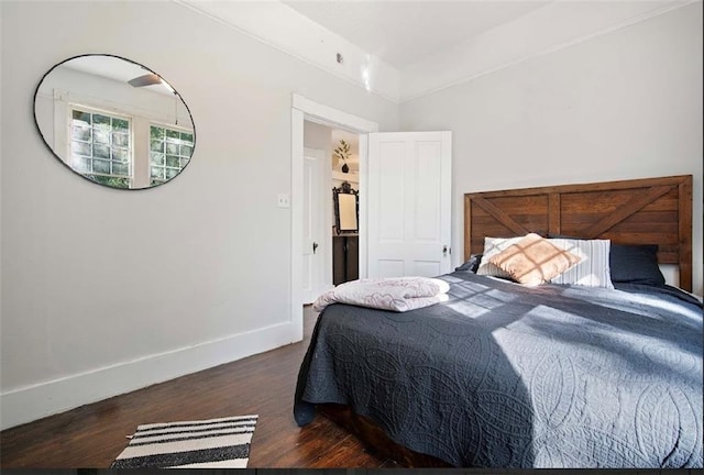 bedroom with dark wood-type flooring