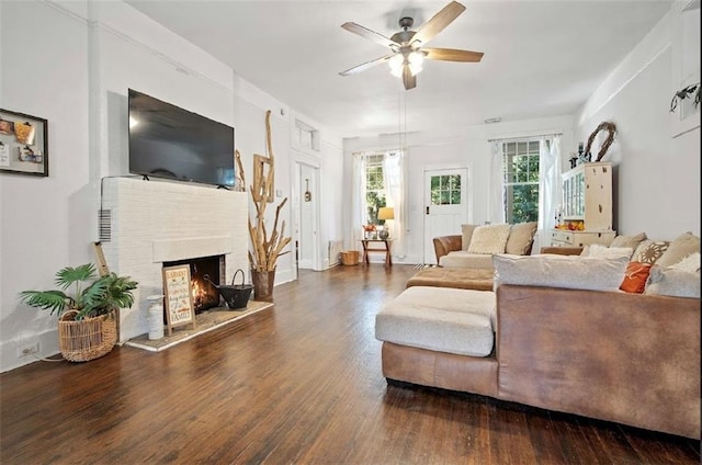 living room featuring ceiling fan and dark hardwood / wood-style flooring