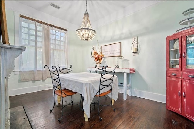 dining area featuring a chandelier and dark hardwood / wood-style flooring