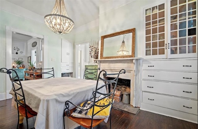 dining space featuring a notable chandelier and dark hardwood / wood-style flooring