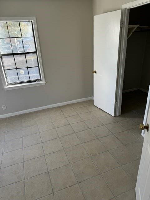 unfurnished bedroom featuring a closet and light tile patterned flooring