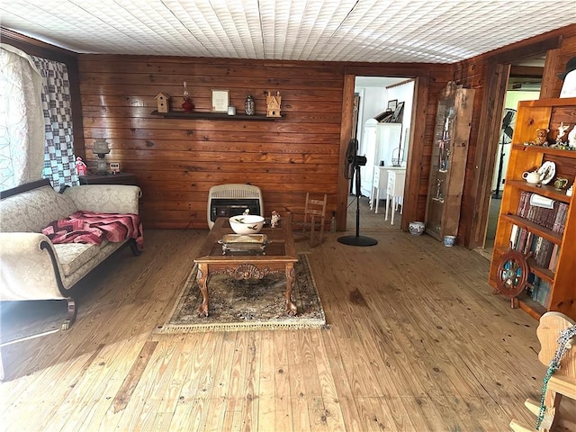 living area featuring wooden walls and hardwood / wood-style floors