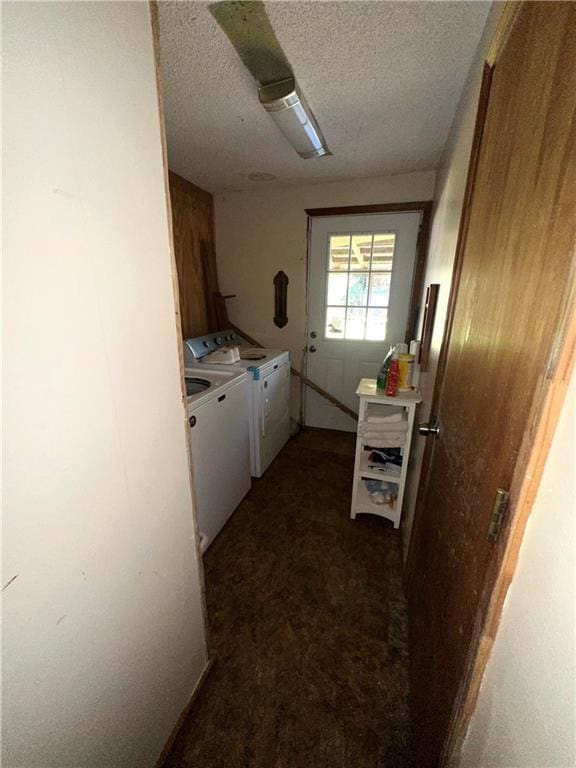 interior space featuring a textured ceiling, carpet, white cabinets, and washer and dryer