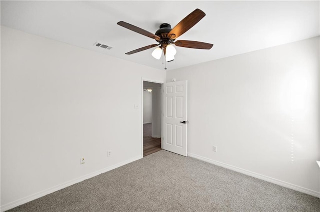 empty room with ceiling fan and carpet flooring