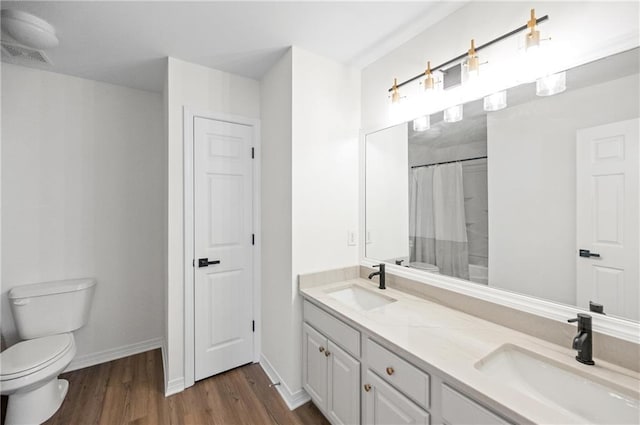 bathroom featuring hardwood / wood-style flooring, vanity, toilet, and a shower with shower curtain