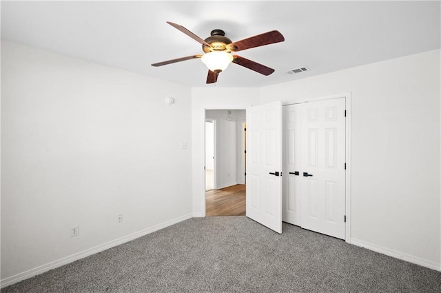 unfurnished bedroom featuring ceiling fan, carpet flooring, and a closet