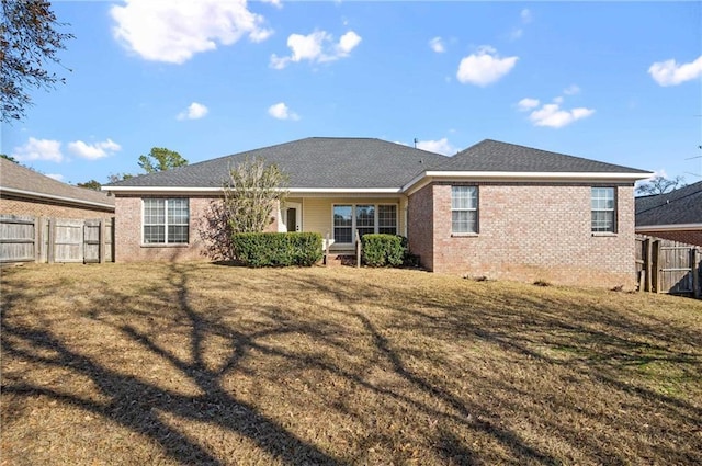 rear view of house featuring a lawn