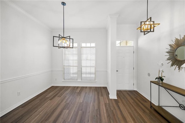 foyer entrance featuring crown molding, an inviting chandelier, and dark hardwood / wood-style flooring