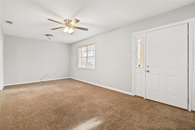 carpeted entrance foyer with ceiling fan