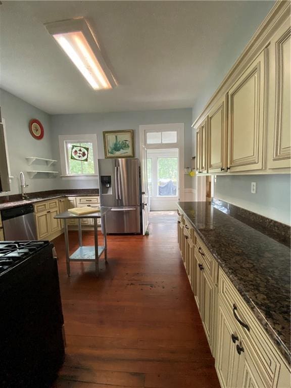 112 Kilmarnock St, Mobile, AL 36604 - kitchen featuring cream cabinets, appliances with stainless steel finishes, and dark wood-type flooring