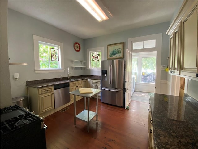 112 Kilmarnock St, Mobile, AL 36604 - kitchen with stainless steel appliances, dark wood-style floors, healthy amount of natural light, and cream cabinets