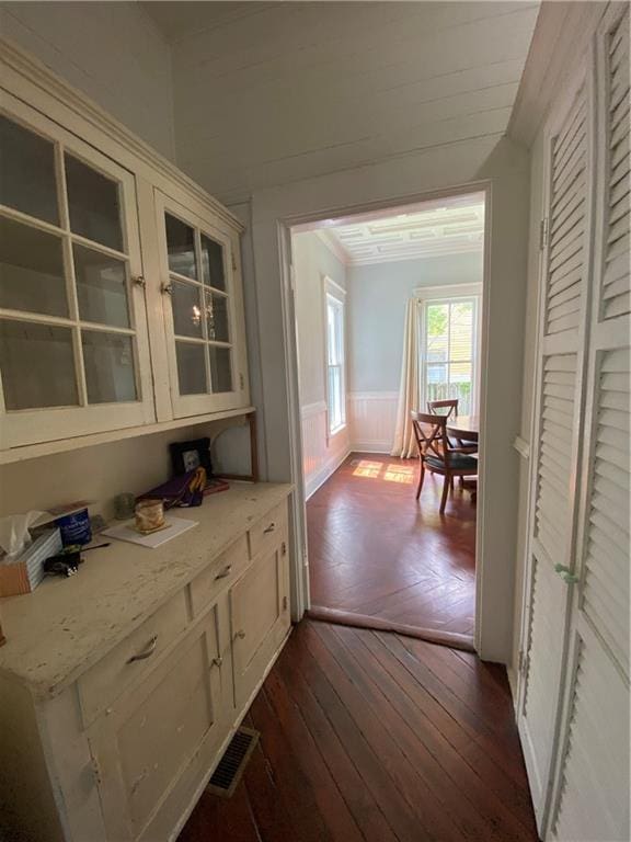112 Kilmarnock St, Mobile, AL 36604 - bar area featuring wainscoting, dark wood-style floors, and ornamental molding
