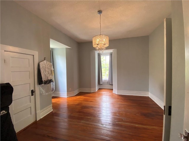 112 Kilmarnock St, Mobile, AL 36604 - unfurnished dining area with a chandelier, hardwood / wood-style flooring, baseboards, and a textured ceiling