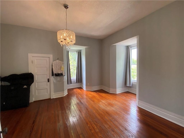 112 Kilmarnock St, Mobile, AL 36604 - spare room featuring hardwood / wood-style flooring, a chandelier, baseboards, and a textured ceiling