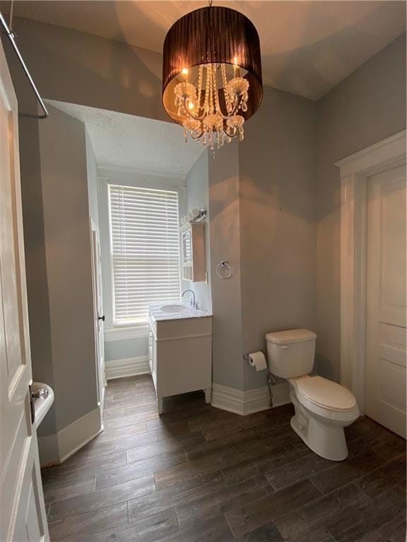 112 Kilmarnock St, Mobile, AL 36604 - full bathroom with baseboards, wood finished floors, and toilet