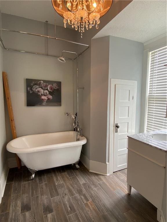 112 Kilmarnock St, Mobile, AL 36604 - full bath with a soaking tub, wood finished floors, baseboards, and vanity