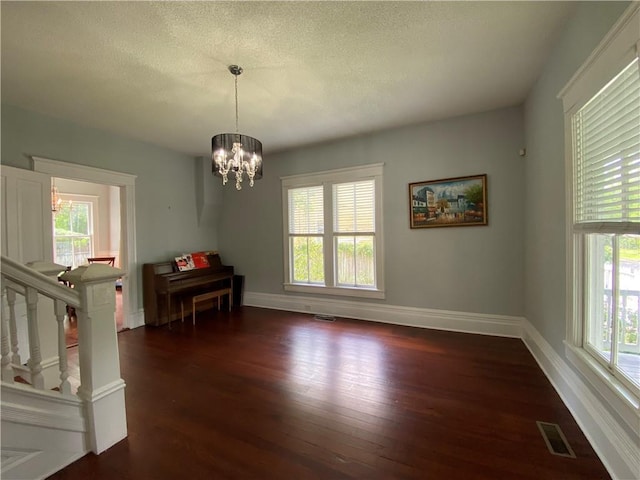 112 Kilmarnock St, Mobile, AL 36604 - dining area with dark wood-style flooring, a chandelier, baseboards, and a textured ceiling