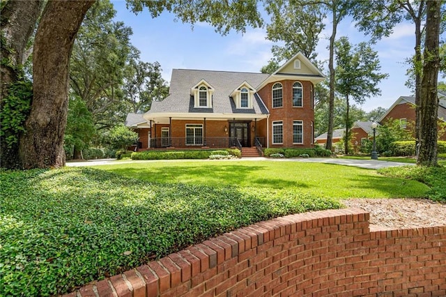 2605 Charleston Oaks Dr W, Mobile, AL 36695 - view of front facade featuring covered porch, a front lawn, and brick siding