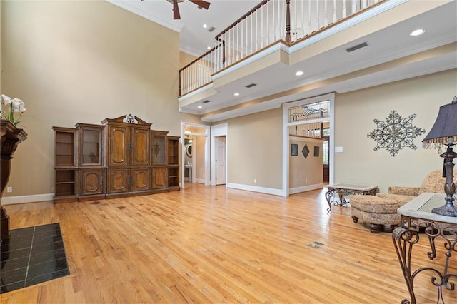 2605 Charleston Oaks Dr W, Mobile, AL 36695 - living area with a towering ceiling, ornamental molding, ceiling fan, light wood-style floors, and recessed lighting