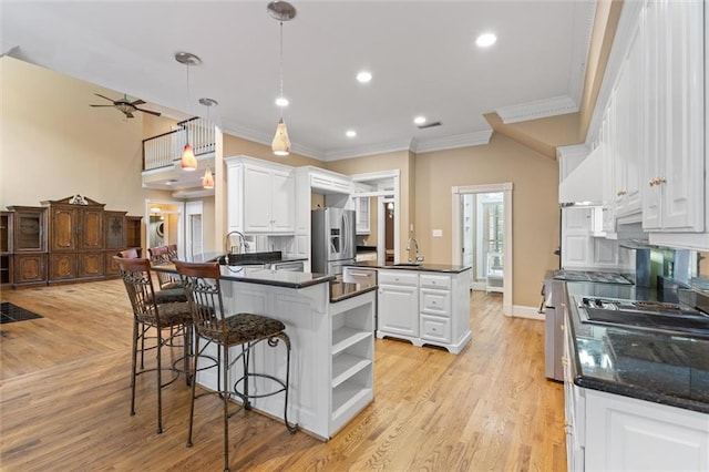 2605 Charleston Oaks Dr W, Mobile, AL 36695 - kitchen featuring a peninsula, stainless steel fridge with ice dispenser, ornamental molding, white cabinets, and light wood-style floors
