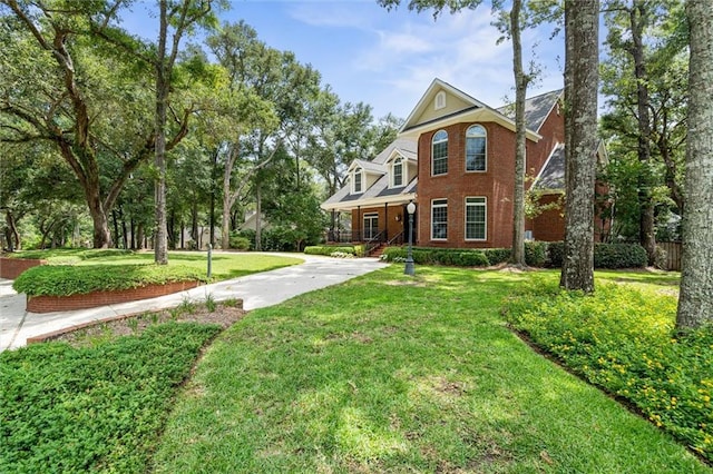 2605 Charleston Oaks Dr W, Mobile, AL 36695 - view of front facade with covered porch, concrete driveway, and brick siding