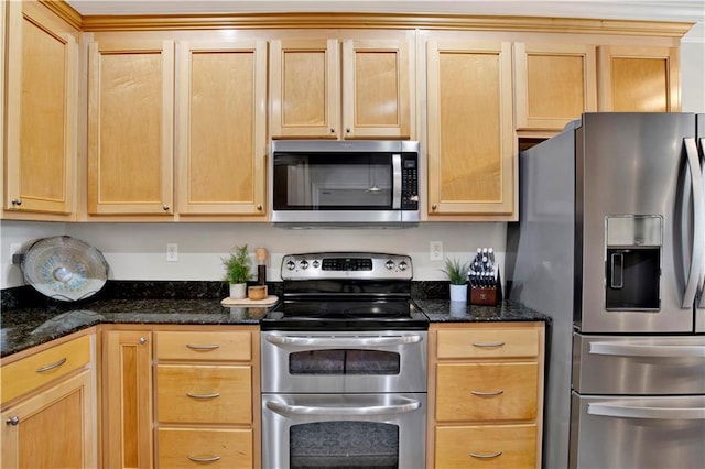 kitchen with stainless steel appliances, dark stone counters, and light brown cabinets