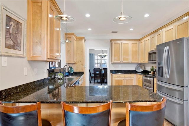 kitchen featuring pendant lighting, stainless steel appliances, and a breakfast bar area