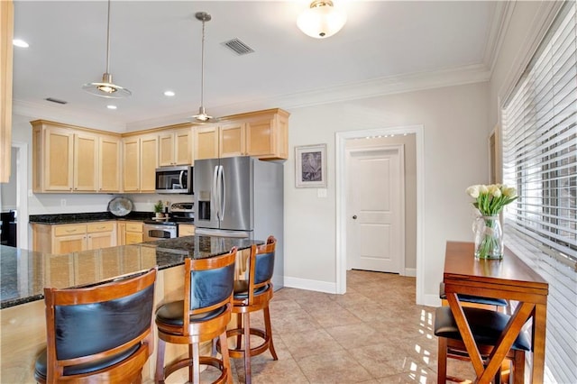 kitchen with dark stone counters, hanging light fixtures, ornamental molding, stainless steel appliances, and light brown cabinets