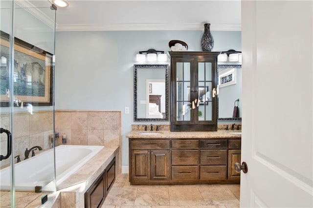 bathroom with crown molding, vanity, and a bathing tub