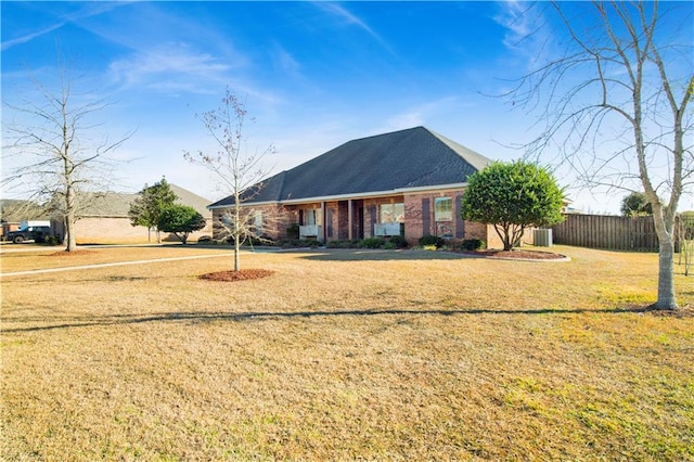 rear view of property featuring a lawn