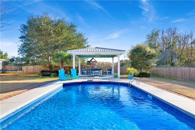 view of swimming pool featuring a gazebo and a trampoline