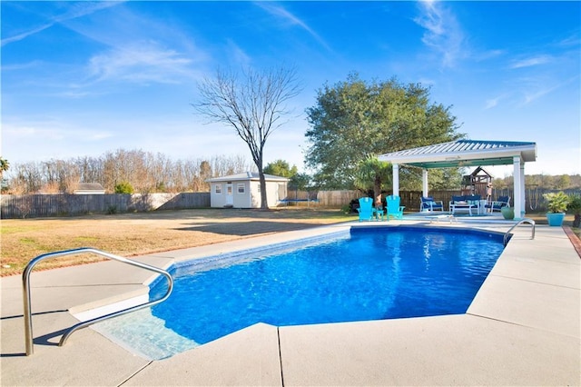 view of pool with a patio and an outdoor structure